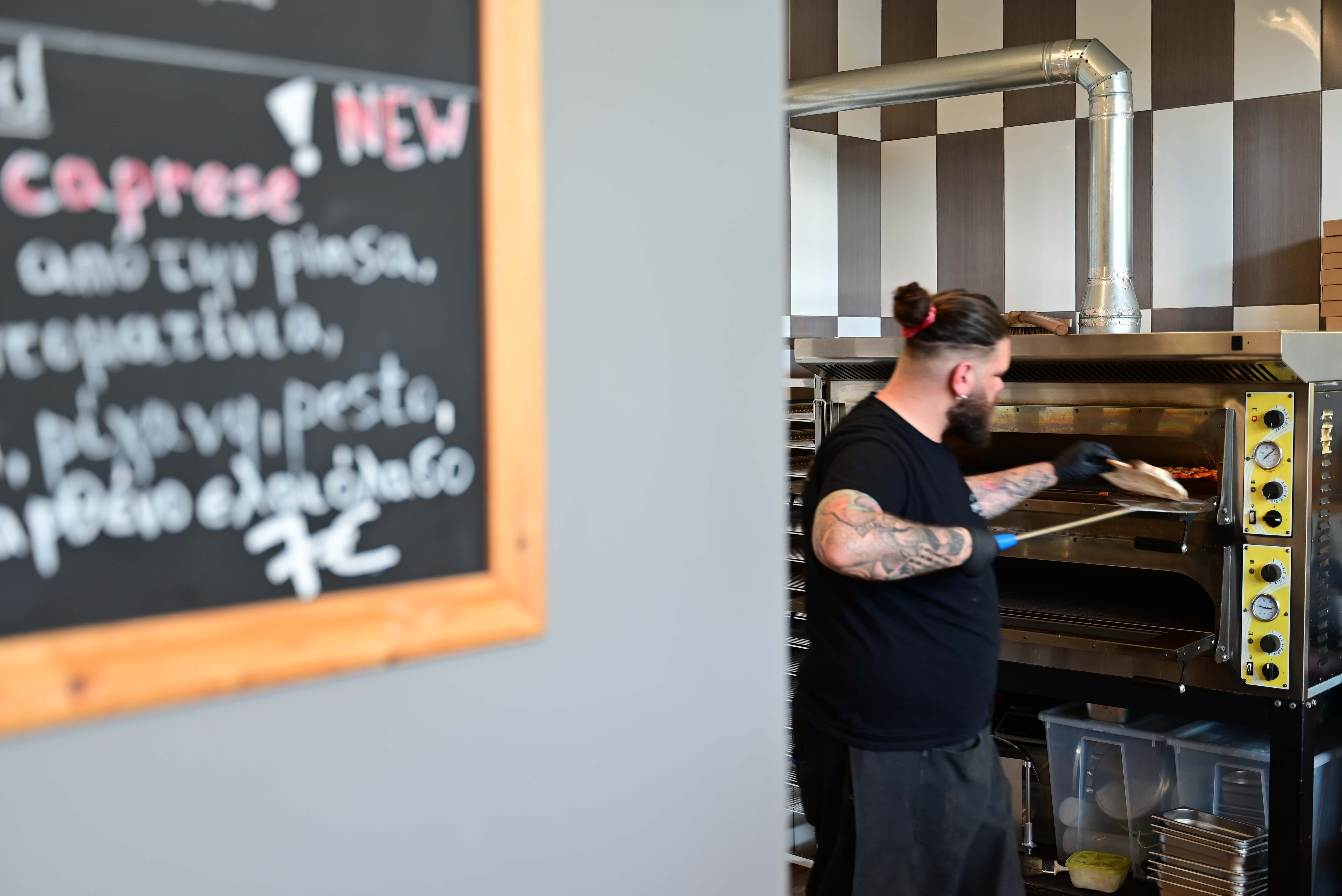 Chef preparing Pinsa in professional oven
